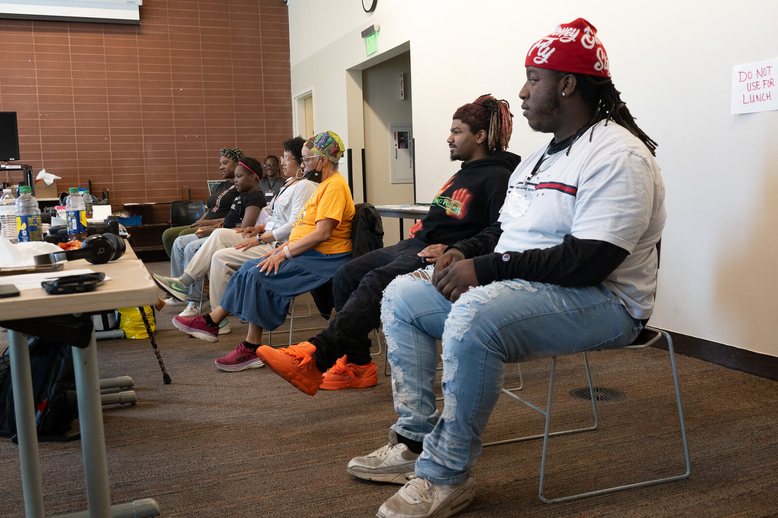 A group of community members of different ages seated together during a workshop